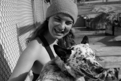 Claire and Sadie smiling in a community garden
