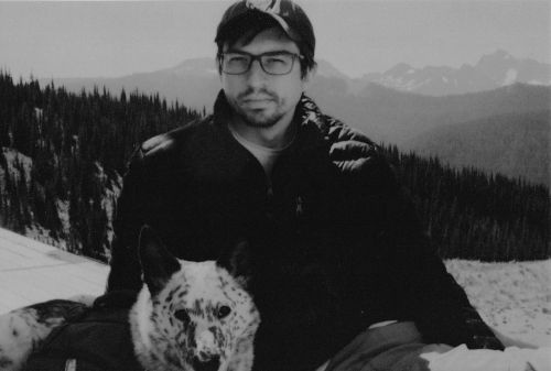 Kellen and Sadie sitting in a mountainous landscape